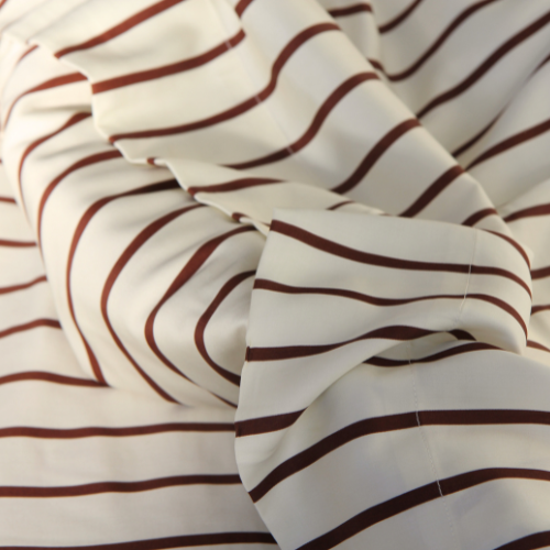 Smooth bamboo top sheet with burgundy and white stripe pattern, fold detail