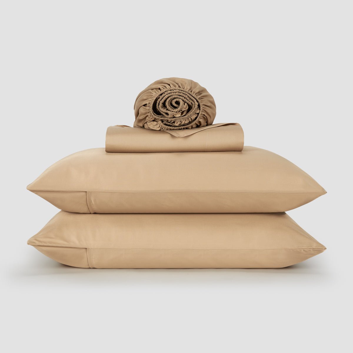 Woman in bed with pink bamboo sheets and pillows – soft, breathable and sustainable bedding