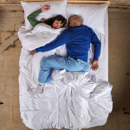 Paar im Bett mit weißem Bambus-Bettbezug-Set, Draufsicht