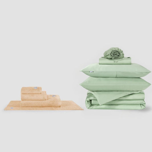 Beige towel set and green bed sheets bundle displayed on white background by Momo Cotton
