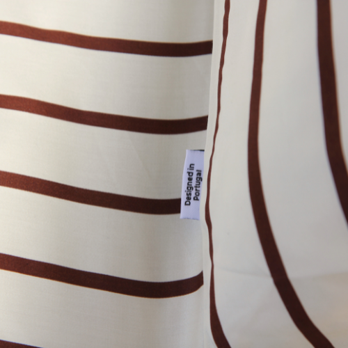Adjustable bamboo fitted sheet with brown and white stripe pattern, side view of silky fabric