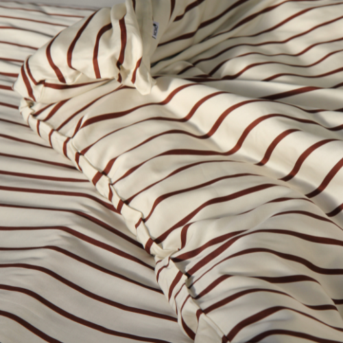 Bamboo striped duvet cover set in red and white displayed on bed