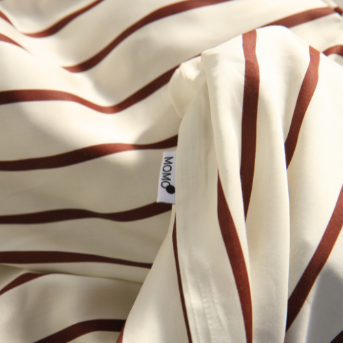 Bamboo duvet cover in cream and brown tones with hidden button detail and silky texture.