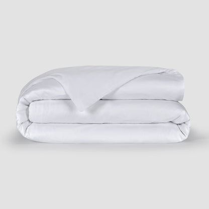 White folded duvet cover showcasing soft 100% bamboo fabric texture with hidden buttons at the bottom